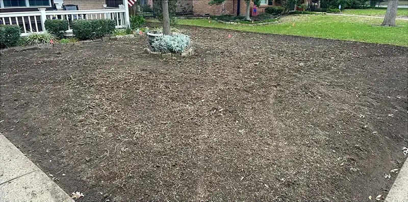 A front yard of bare dirt before the new lawn